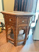 Overall view of side table showing octagonal form, inlay on sides and legs