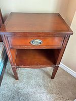 Front view of one nightstand showing drawer and shelf