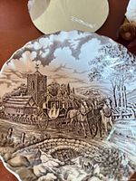 Close view of scenic transferware plate and partial pig figurine