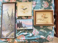 Group shot showing four of the framed art pieces on floral fabric