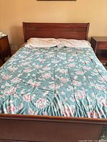 Full size sleigh bed with mattress, headboard and footboard visible