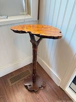 Full view of live edge side table showing slab top, branch pedestal and root base