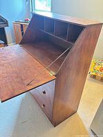 Desk angled view with drop-front open showing interior cubbies and drawers