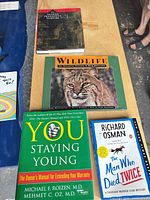 Four books laid out on table including grammar, wildlife, health, and mystery titles