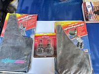Overall lot showing two packaged mudflaps and packaged bulbs