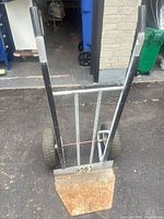 Full front view of steel hand truck showing handles, frame and toe plate