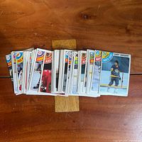 Stack of vintage 1978-79 O-Pee-Chee hockey cards on tabletop, about 50 cards