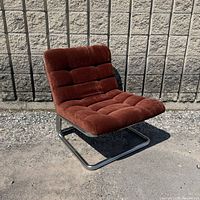 Front angle of chrome lounge chair showing upholstery and frame