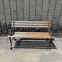Front view of bench showing cast iron ends and wood slats