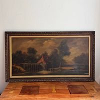 Full view of framed watermill oil painting