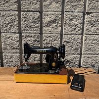 Full view of Singer 99K sewing machine on base with foot pedal