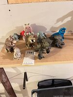 Group shot of all eight animal figurines on shelf