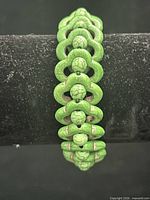 Full view of green dyed howlite stretch bracelet standing upright