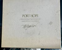 Top of off-white box with title, edition size and signature visible, showing stains