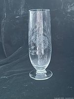 Full view of clear glass vase with etched floral pattern on pedestal base