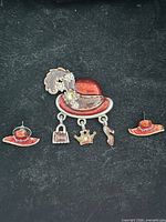 Front view of brooch and both stud earrings on black background