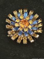 Front view of brooch showing sunburst rhinestone arrangement