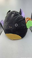 Full view of Squishmallows Fariq bat plush showing tag and features