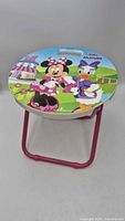 Top view of Disney Junior Minnie Mouse folding stool showing seat graphic and frame