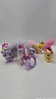 Front view of five Palace Pets figurines showing colors, crowns and fur tails