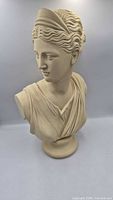Front angled view of cream female bust on pedestal