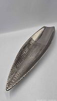 Full view of elongated silver-tone centerpiece showing overall shape and texture