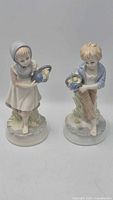 Front view of both porcelain figurines