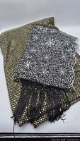 Scarf and folded metallic dotted fabric together