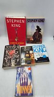 All six Stephen King books standing and lying flat