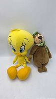 Tweety Bird and Yogi Bear plush toys side by side
