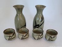 Front view of full sake set with two flasks and four cups
