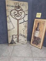 Both wall art pieces standing side by side for size comparison