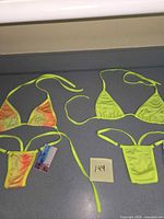 two complete micro bikini sets laid out showing tops and bottoms