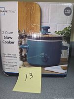 Front of boxed Mainstays 2-Quart Slow Cooker