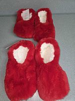 Four red faux fur slipper socks showing exterior and lining