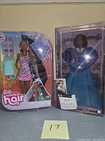 Front view of both boxed Barbie dolls
