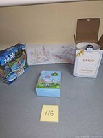 Three boxed items: pool, toy camera, YiMOO lamp