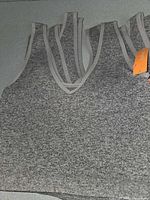 Stack of identical gray heather Colsie tank tops showing fabric and neckline