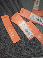 Close view of Colsie tags showing size XL, price, and SKU