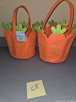 Pair of orange felt carrot Easter baskets on countertop with lot number note
