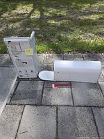 Mailbox, flag, and retail box on paving stones