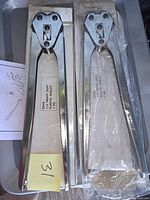 Two chrome ES48 strap sealers in boxes, one bagged