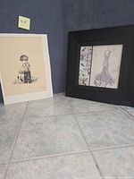 Both art pieces side by side showing framing and scale