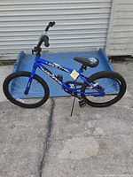 Right side view of blue Huffy Rock It bicycle showing frame, wheels and kickstand