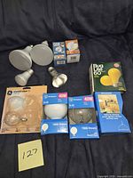 All bulbs laid out showing loose reflector bulbs, boxed reflector bulbs, globe bulbs and Bug Lite box