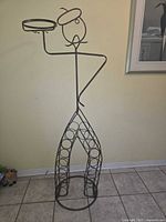 Full view of metal figure wine rack front