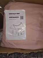 User manual on folded pink tent fabric