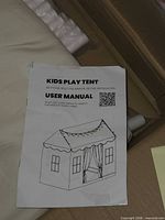 User manual showing illustration of house-style play tent