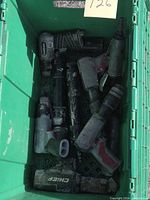 Top view of green bin containing multiple pneumatic tools showing overall quantity and condition