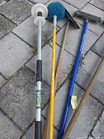 Group of long-handle tools showing blue Marshaltown sanding pole with silver extension and black head